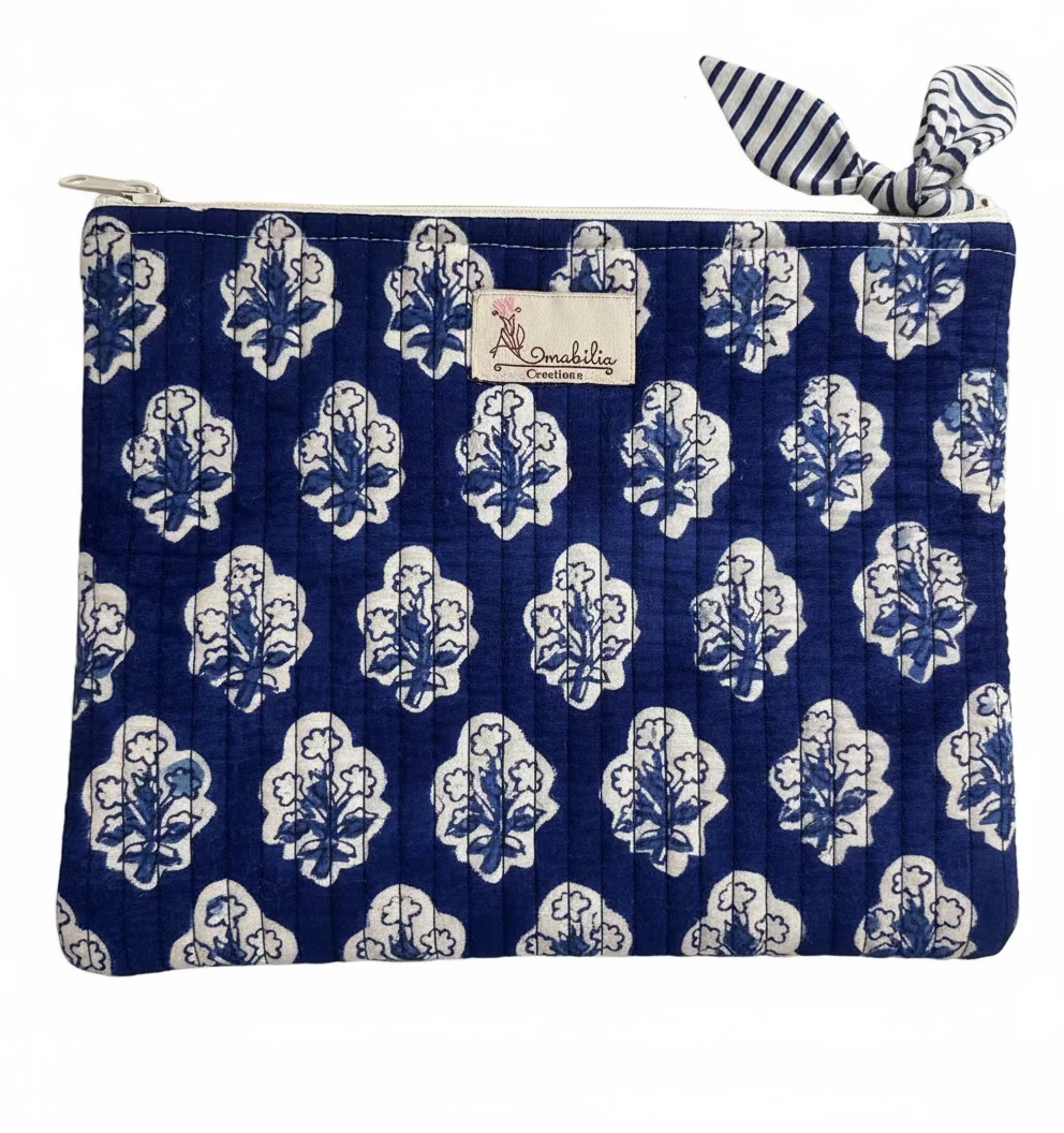 Blue floral-patterned pouch with a brand label on a white background