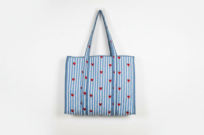 Tote bag with blue and white stripes and red hearts on a beige background