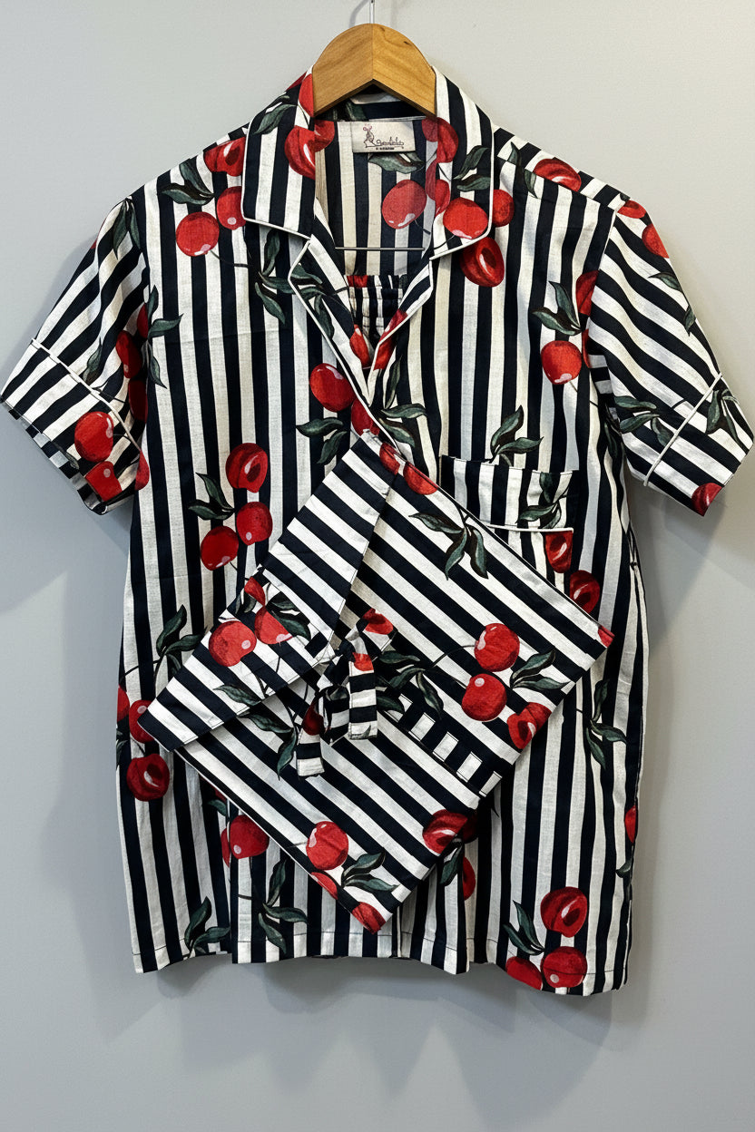 Blue and white striped fabric with red cherries on a wooden surface